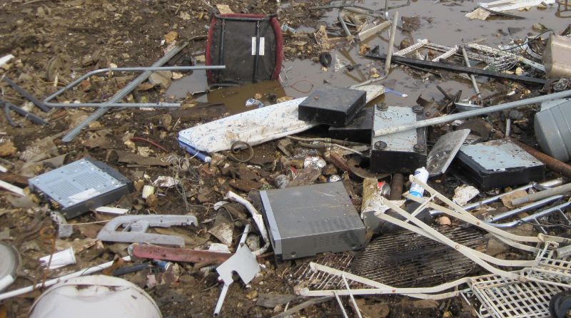 15 surprising e waste facts - a rubbish site with several e-waste items that haven't been recycled correctly.