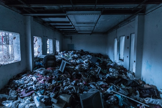 Abandoned building with piles of e-waste and rubbish
