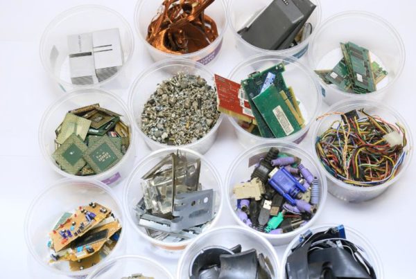 E-Waste components being sorted into different containers.